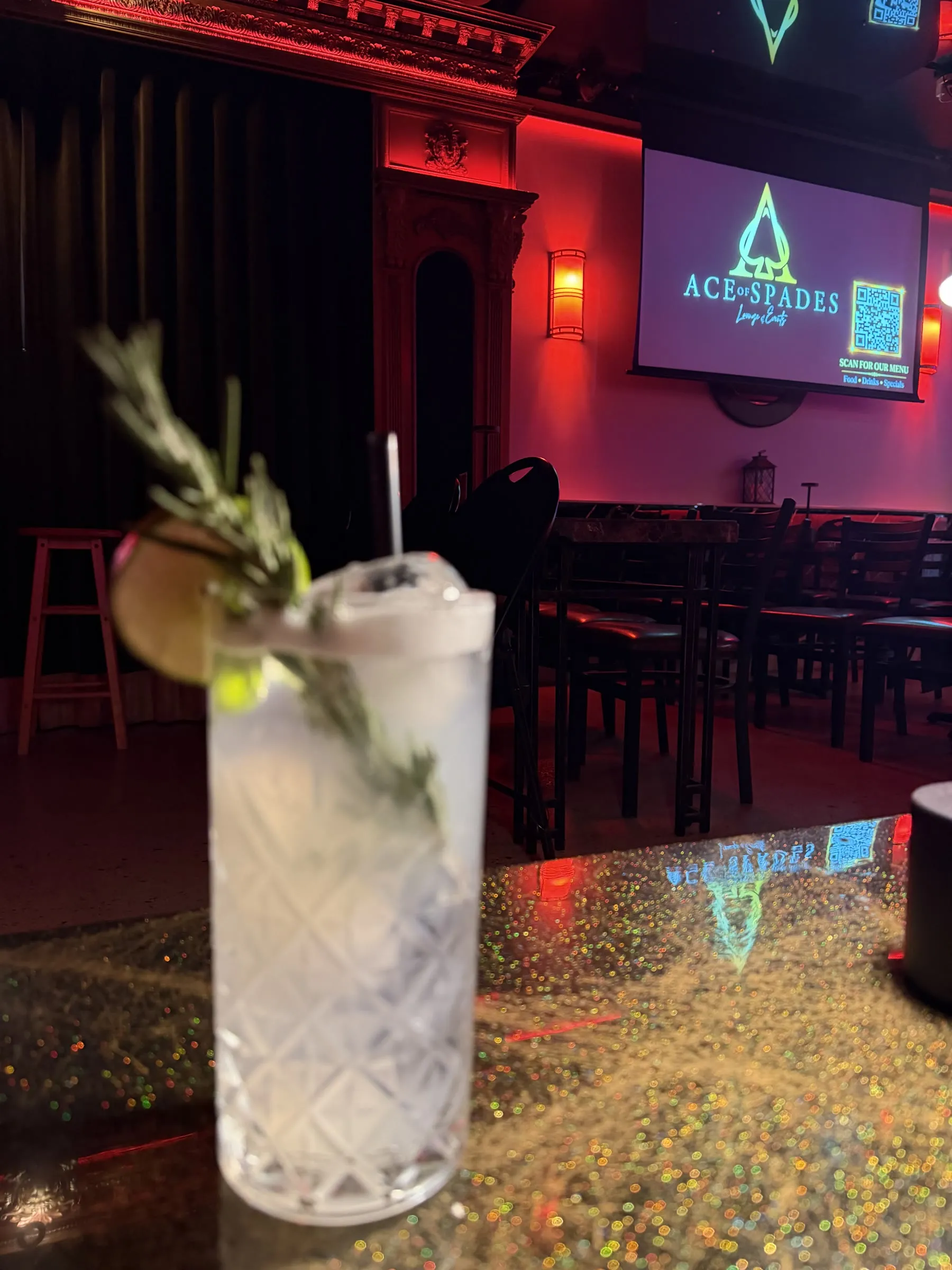 Gin Smash on the lounge bar with the Ace of Spades screen behind it