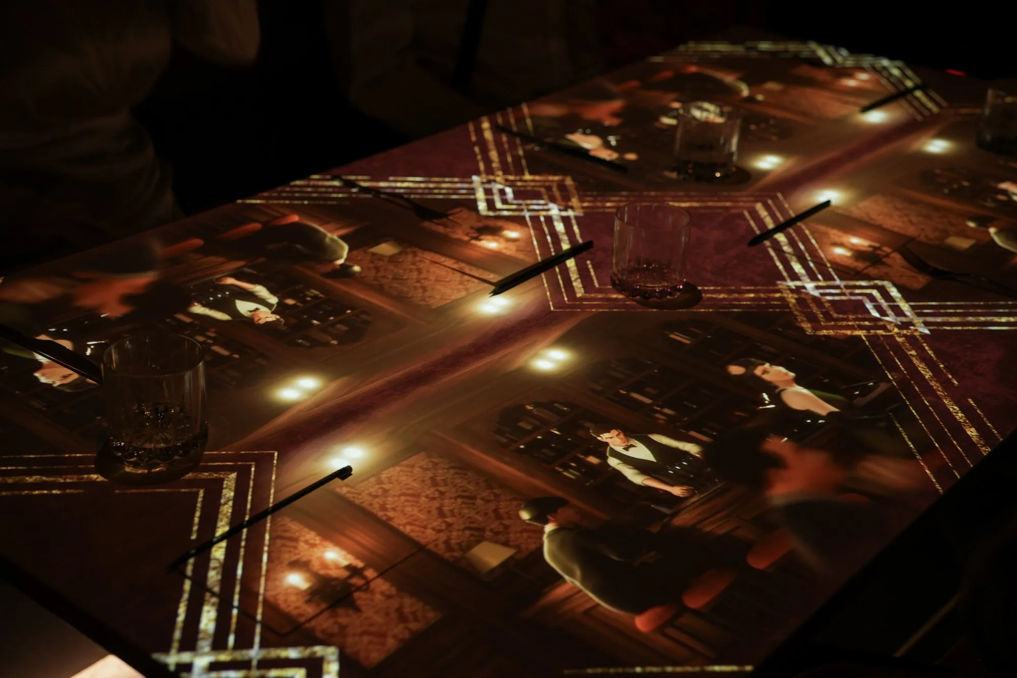 1920s characters projected across the dining table between cocktails and cutlery